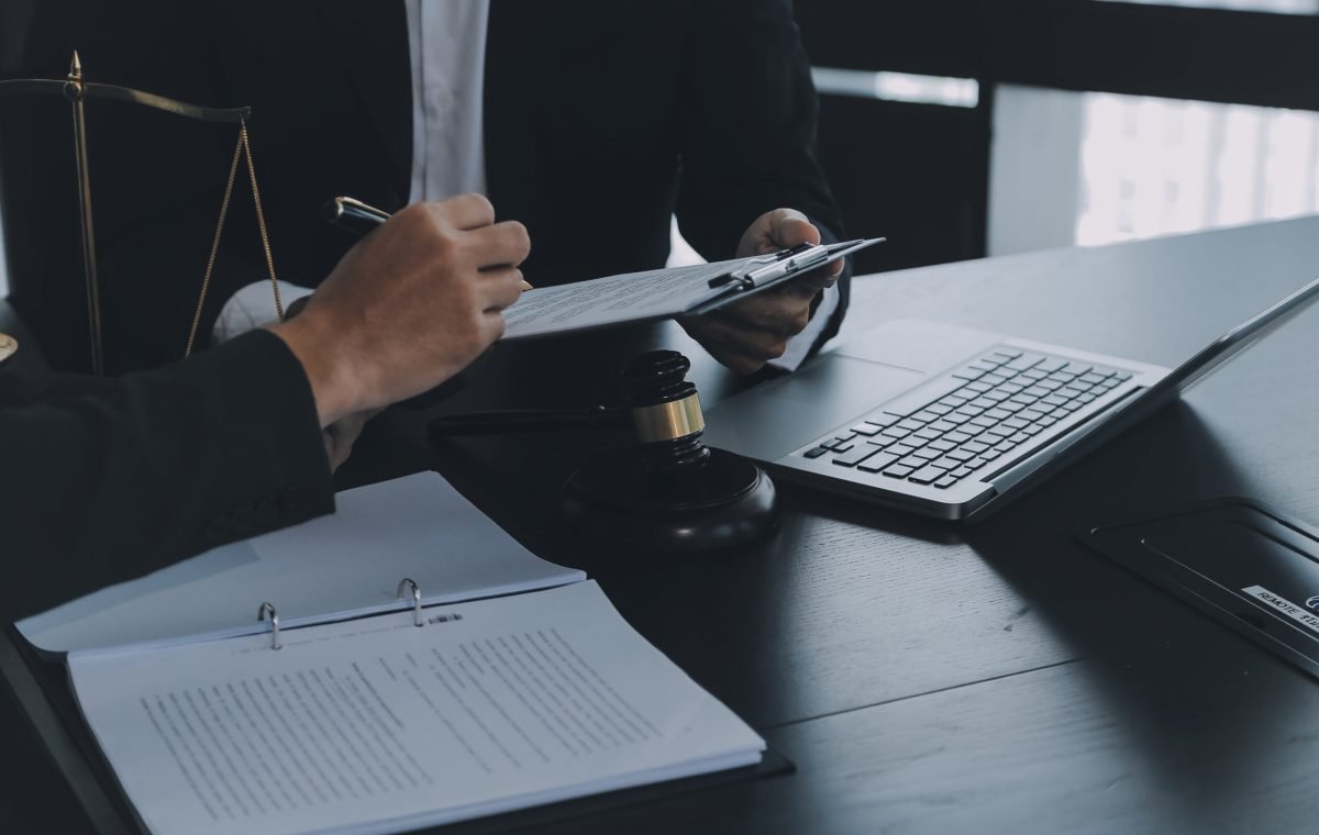 Consultation and conference of Male lawyers and professional businesswoman working and discussion having at law firm in office. Concepts of law, Judge gavel with scales of justice.